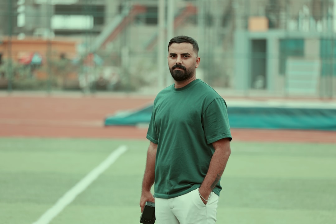 A man standing on a tennis court holding a tennis racquet