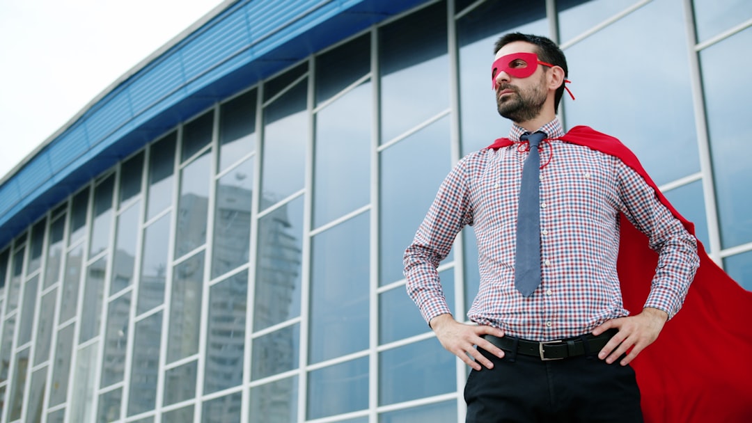 Man in superhero costume standing outside building